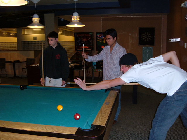 Jacob, Towa, and Andrew playing pool in the CC