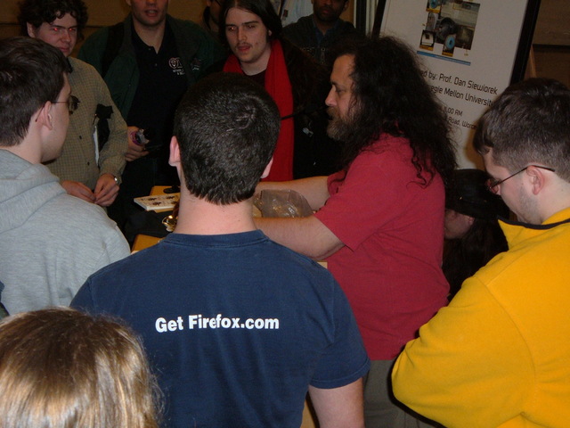 Stallman selling FSF merch (extra credit: getfirefox.com t-shirt)